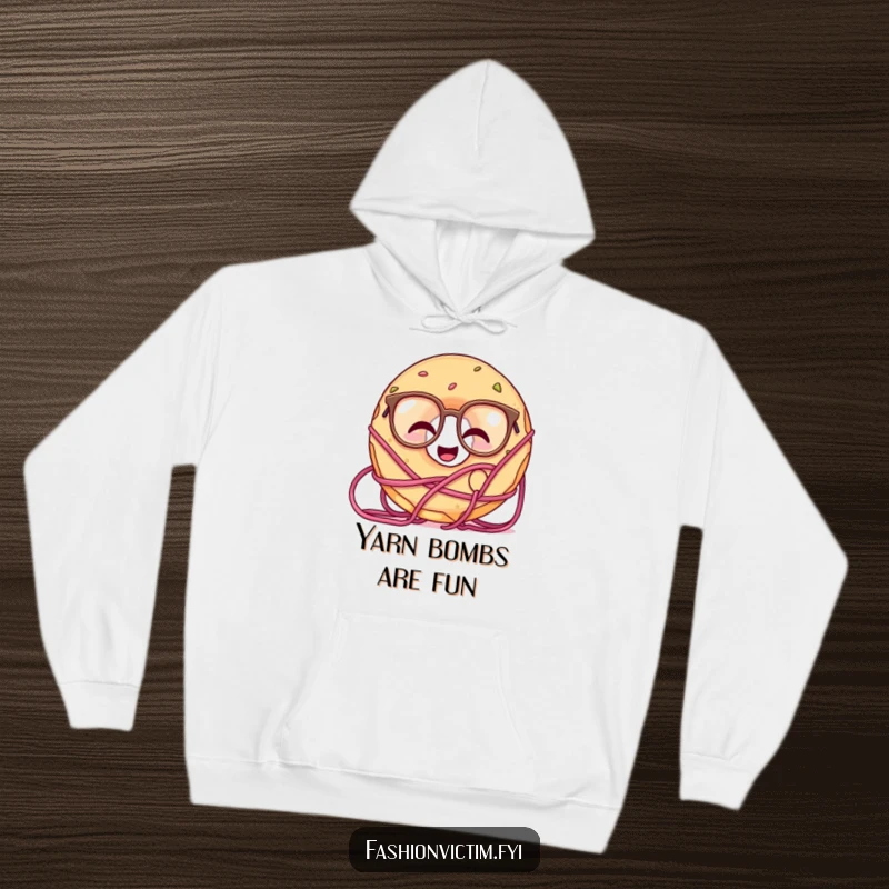 Funny hoodie depicting a giggling doughnut with oversized glasses, getting happily tangled in skeins of yarn.