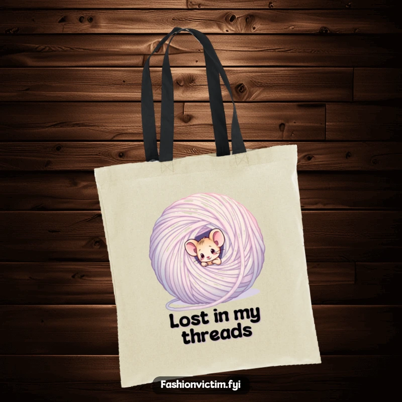 Funny mouse tote bag, a tiny confused mouse entangled in a large shimmering ball of yarn, carrying supplies.