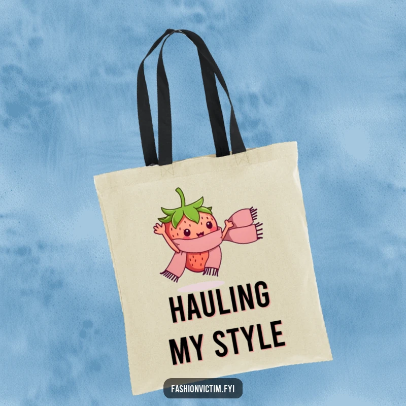 Funny tote bag featuring a tiny strawberry character waving a miniature stylish scarf. Humorous and cute accessory.